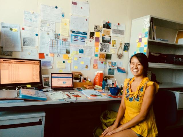 Jen Nguyen sitting at their desk