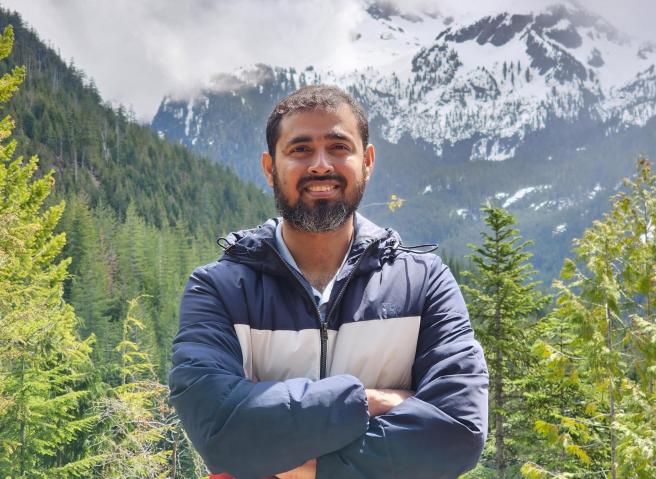 Headshot of Dr. Md Mahamud ur Rashid with mountains in the back