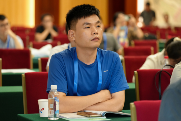 Asian man sitting at a table