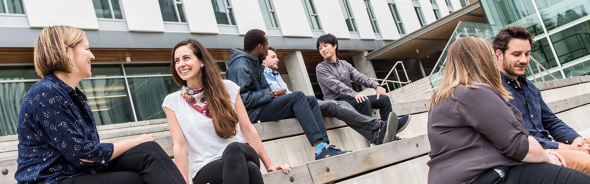 postdocs sitting on the steps talking