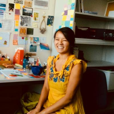 Jen Nguyen sitting at their desk